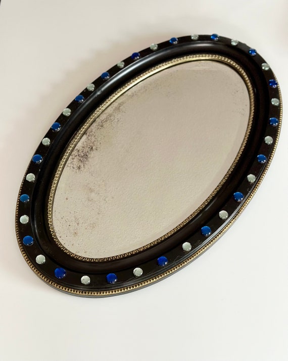 Irish ebonised oval mirror circa 1830 regency period