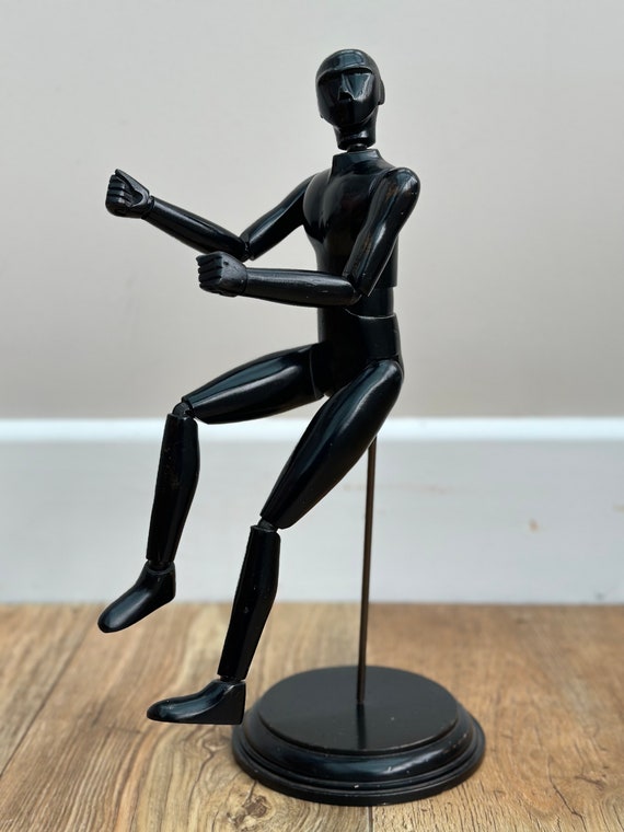 Artists articulated lay figure in ebonised finish on stand