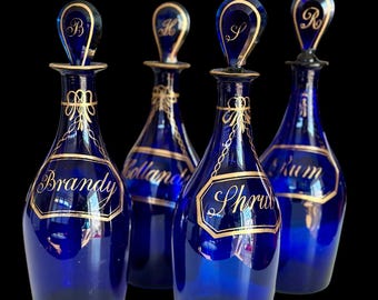 English Regency Bristol blue set of four decanters with gilded labels circa 1820