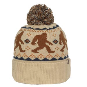 May include: A beige knit beanie with a brown pom pom and a repeating pattern of brown Bigfoot figures. The beanie has a navy blue and orange trim.