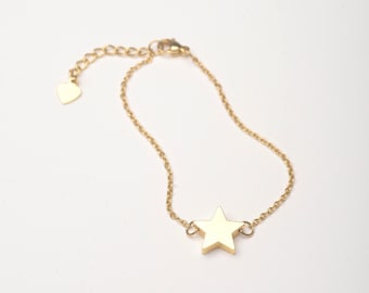 May include: A gold chain bracelet with a star charm. The chain is delicate and the star is simple and elegant.