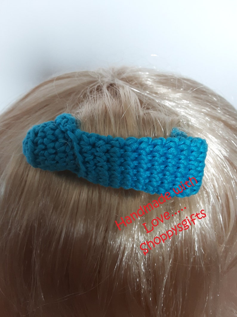May include: A teal blue crocheted hair clip with a knot on the top. Handmade with love... Shoppygifts.