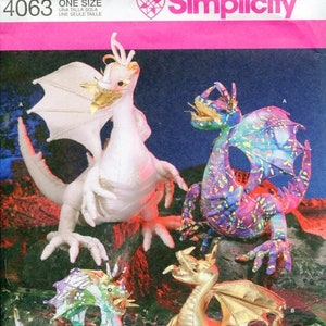May include: A Simplicity sewing pattern for making four different dragon stuffed toys. The pattern includes instructions for making a white dragon, a purple and green dragon, a green and white dragon, and a gold dragon. The pattern is for one size.
