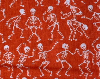White Dancing Skeletons on Orange Cotton Fabric:  Sold by FQ