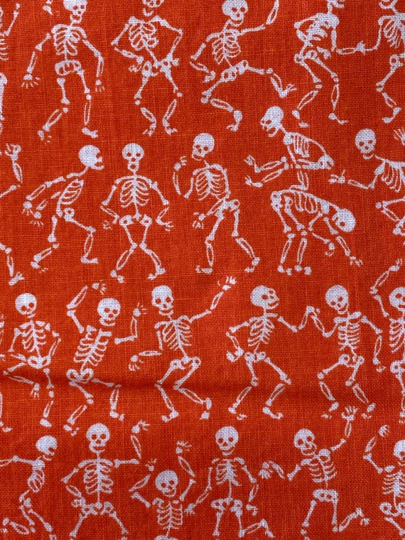 White Dancing Skeletons on Orange Cotton Fabric:  Sold by FQ