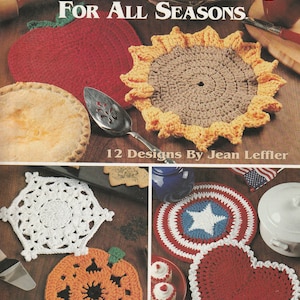 May include: A book titled "Hot Pads For All Seasons" with 12 crochet designs. The cover features a red apple, a yellow sunflower, a white snowflake, a pumpkin, a red, white, and blue star, and a red heart.