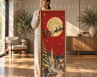 May include: A tall, rectangular diamond painting in a gold frame featuring a Christmas scene with Santa Claus in a sleigh pulled by reindeer flying across a large full moon against a red sky, above a snowy village with a church and pine trees.