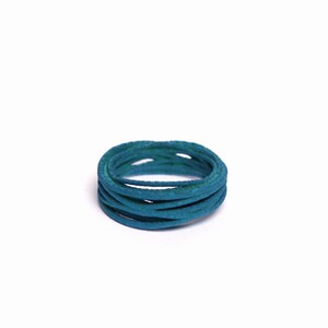 May include: A coil of teal blue cord, wrapped in a circle.
