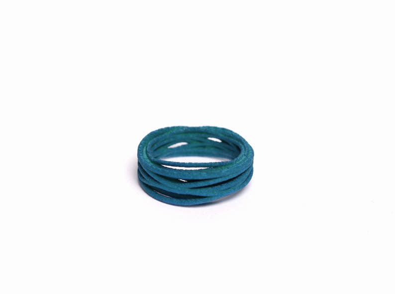May include: A coil of teal blue cord, wrapped in a circle.