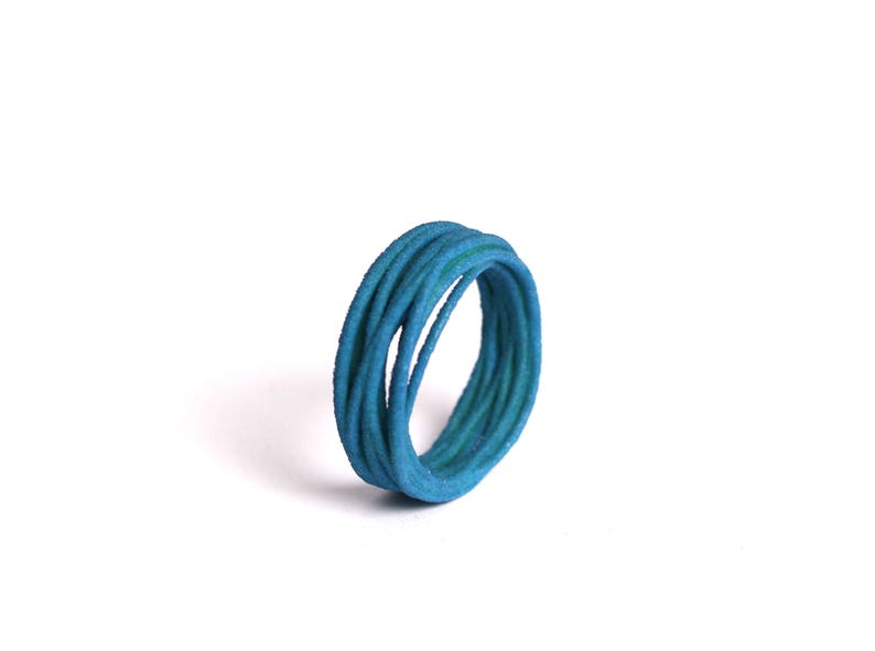 May include: A blue ring made of multiple strands of woven cord.