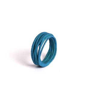 May include: A blue ring made of multiple thin strands of wire twisted together.