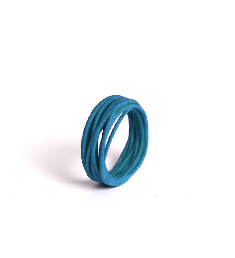 May include: A blue ring made of multiple thin strands of wire twisted together.