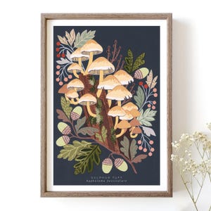 May include: A framed illustration of a cluster of yellow mushrooms growing on a tree trunk. The background is a dark blue color and the mushrooms are surrounded by green leaves and red berries. The text "SULPHUR TUFT" and "hypholoma fasciculare" is printed below the illustration.