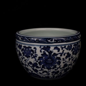 May include: A white ceramic bowl with a blue and white floral pattern. The bowl is round and has a wide rim.
