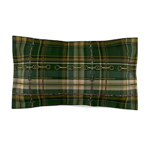 May include: A rectangular pillow sham featuring a dark green, tan, and black plaid pattern overlaid with a repeating graphic print of gold and silver equestrian-style horse bit hardware and thin chain links arranged in a grid-like formation.