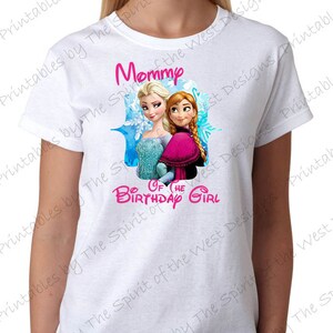 May include: White t-shirt with a pink graphic of Elsa and Anna from Frozen. The graphic says "Mommy of the Birthday Girl".