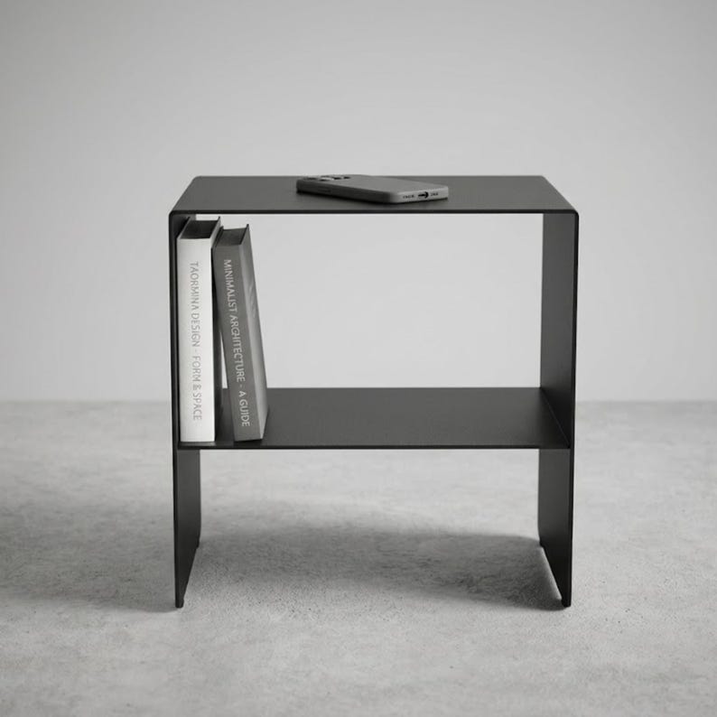 CARINI metal nightstand in matte black textured steel, handcrafted in Italy by Taormina Design, shown as a modern bedside table with an internal shelf, minimalist industrial lines, 4 mm steel structure and compact design for contemporary bedrooms.