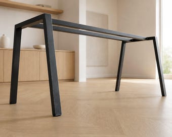 May include: A black metal table frame featuring four angled legs connected by two parallel horizontal support bars at the top. The structure is rectangular in shape with a clean, open design, providing a sturdy base for a tabletop surface.