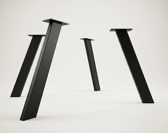 May include: A set of four matte black metal furniture legs, each featuring a tapered, angled design with a flat rectangular mounting plate at the top. These sturdy components are positioned upright, showcasing a clean, uniform finish and structural form.