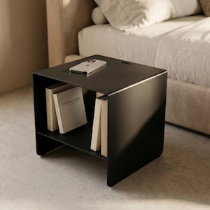 CARINI modern nightstand in powder-coated metal, shown with a clean industrial silhouette and practical internal shelf, perfect for storing books, magazines and small objects in contemporary bedrooms, loft interiors and minimalist living spaces.