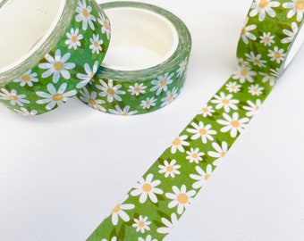 Può includere: Tre rotoli di nastro washi verde con un motivo di margherita bianca. Il nastro è srotolato per mostrare il design.