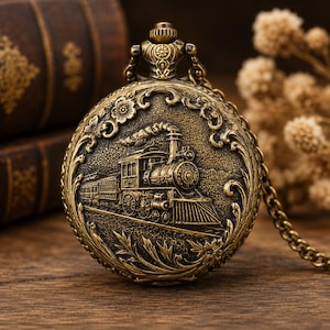 May include: Vintage brass pocket watch with a detailed train engine design. The watch has an ornate floral border and a matching chain. A classic, vintage style accessory.
