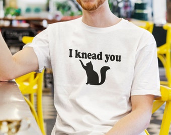 Cat pun T-shirt. I knead you kneading cat short sleeve graphic tee. Kitty biscuits animal pun shirt.