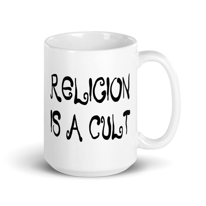 15 ounce white ceramic mug with the phrase Religion is a cult printed on both sides.