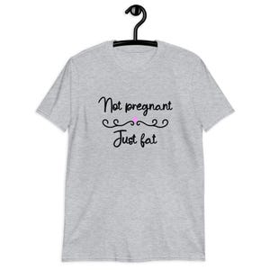 Sport grey t-shirt with the phrase Not pregnant just fat printed on the front with a small pink heart.