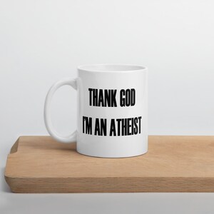 11 ounce white ceramic mug with the Thank God Im an Atheist printed on both sides.