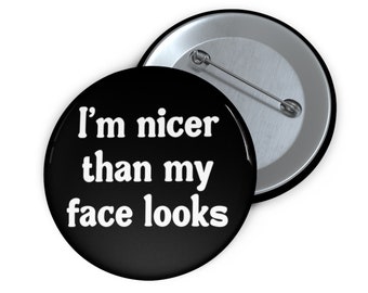 I'm nicer than my face looks pin-back button.