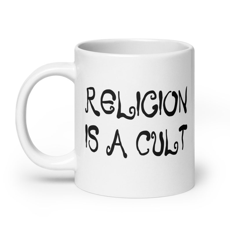 20 ounce white ceramic mug with the phrase Religion is a cult printed on both sides.