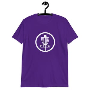 Purple t-shirt with an image of disc golf basket silhouette with a circle around it printed on the front.