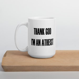 15 ounce white ceramic mug with the Thank God Im an Atheist printed on both sides.