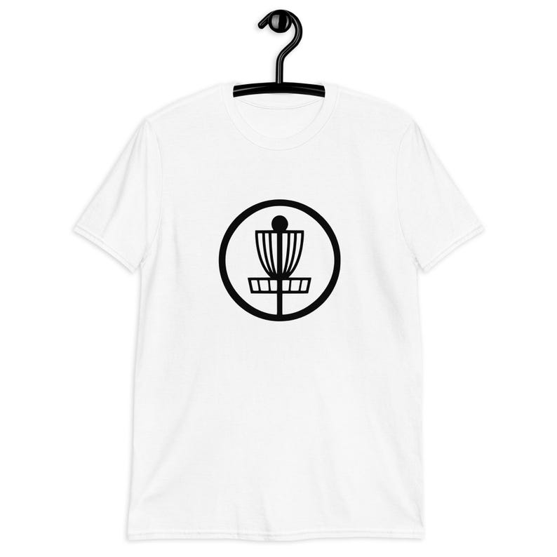 White t-shirt with an image of disc golf basket silhouette with a circle around it printed on the front.
