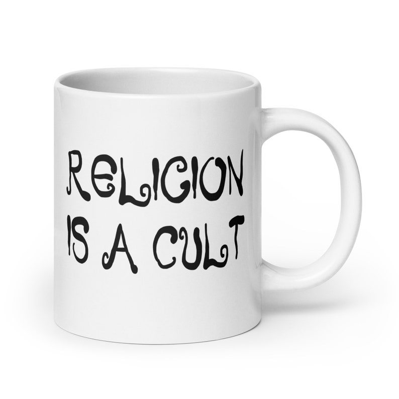 20 ounce white ceramic mug with the phrase Religion is a cult printed on both sides.