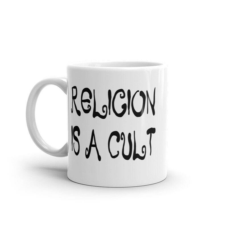 11 ounce white ceramic mug with the phrase Religion is a cult printed on both sides.