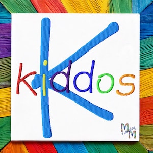 May include: Embroidered design of the word "kiddos" with a large blue letter "K" in the center. The letters are in different colors: red, yellow, purple, blue, green, and orange.