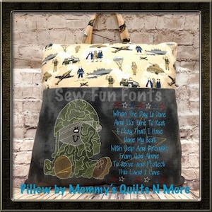 May include: A grey and beige pillow featuring a camouflage-patterned teddy bear and an embroidered patriotic poem on the front. The poem reads: "When the day is done and it's time to rest, I pray that I have done my best, with help and strength from God above, to serve and protect this land I love."