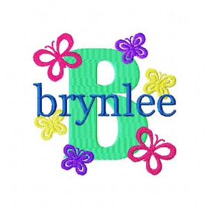 May include: A green letter B with the name "brynlee" in blue letters below. The letter B is surrounded by colorful butterflies in pink, yellow, purple, and blue.