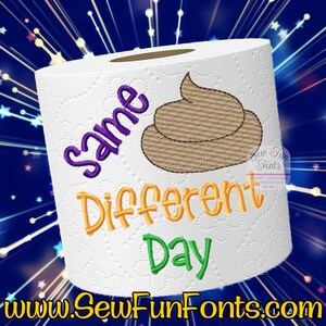 May include: A white toilet paper roll with the text "Same Different Day" and a brown poop emoji embroidered on it.