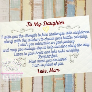 May include: A blue and white embroidered card with a heart and the text "To My Daughter" and a message to her daughter about facing challenges with confidence, choosing battles carefully, and always helping others. The card also says "Remember how much you are loved. I am so proud of you. Love, Mom."
