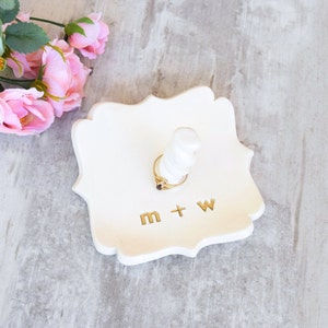 custom gold monogram personalize ring dish with post is large fancy square ceramic tray, handmade pottery jewelry storage with 2 inch tall ring cone in center. Engraved with 2 gold initials letters, wedding ring holder engagement gifts for couples.