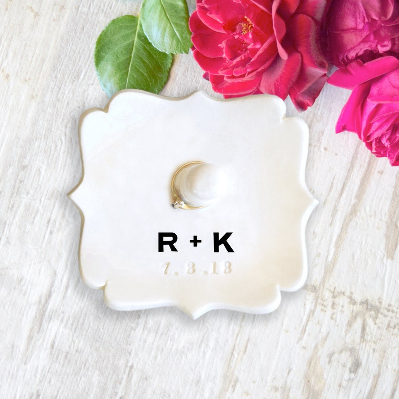 custom black monogram personalize ring dish with post is large fancy square ceramic tray, handmade pottery jewelry storage with 2 inch tall ring cone in center. Engraved with 2 gold initials letters, wedding ring holder engagement gifts for couples.