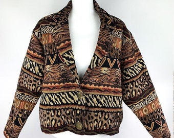 May include: A brown, black, and beige patterned jacket with a V-neck and long sleeves. The jacket has a button closure and is made of a woven fabric.