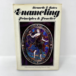 May include: Book cover with the title "Enameling Principles & Practice" by Kenneth F. Bates. The cover features a colorful illustration of a woman in a purple and blue robe holding a flame.
