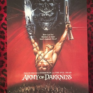 May include: A movie poster for the film "Army of Darkness" featuring a muscular man holding a shotgun and a chainsaw, with a demonic creature in the background. The text on the poster reads "How can you destroy an army that's already dead?" and "From the director of Darkman and The Evil Dead".