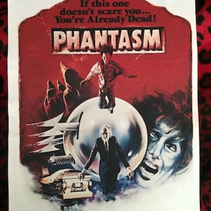 May include: A vintage movie poster for the horror film Phantasm. The poster features a red background with the title "Phantasm" in white letters. The poster also features a young boy standing on a large, silver sphere, and a man in a suit standing in front of a coffin. The poster includes the text "If this one doesn't scare you... You're Already Dead!"