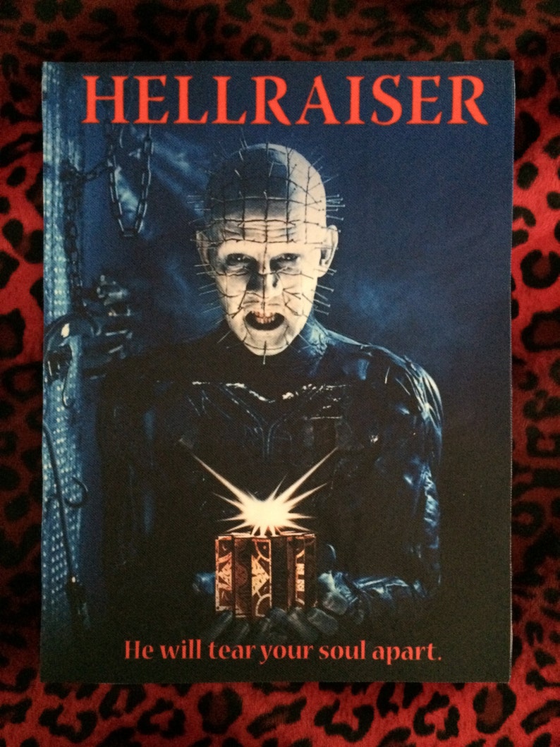 May include: A movie poster for the horror film Hellraiser. The poster features a character with hooked, barbed, and spiky skin, holding a small, ornate box. The text on the poster reads "Hellraiser" and "He will tear your soul apart."