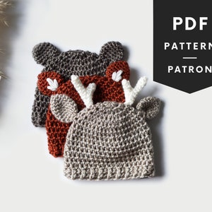 May include: Three crocheted hats in different colors, stacked on top of each other. The top hat is gray with white antlers, the middle hat is orange with white ears, and the bottom hat is gray with brown ears. The hats are on a white surface. PDF PATTERN PATRON